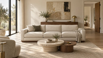 Concept 3D rendering of a cream sofa, round coffee tables and walnut cabinet in a neutral living room.