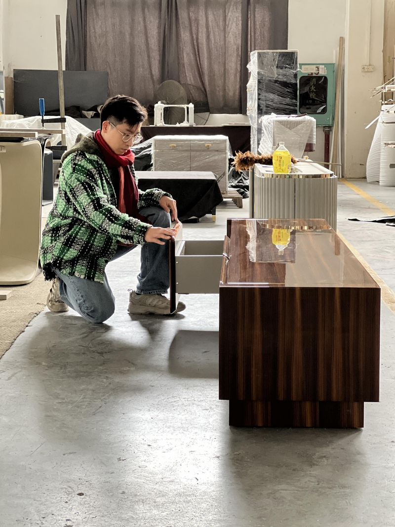 A cabinet and drawer being reviewed on a factory floor