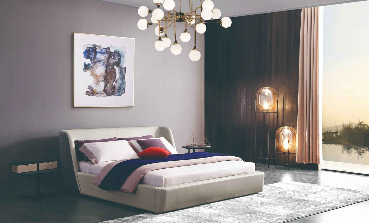 Light-colored upholstered TC1-013A bed with a broad headboard in a styled bedroom
