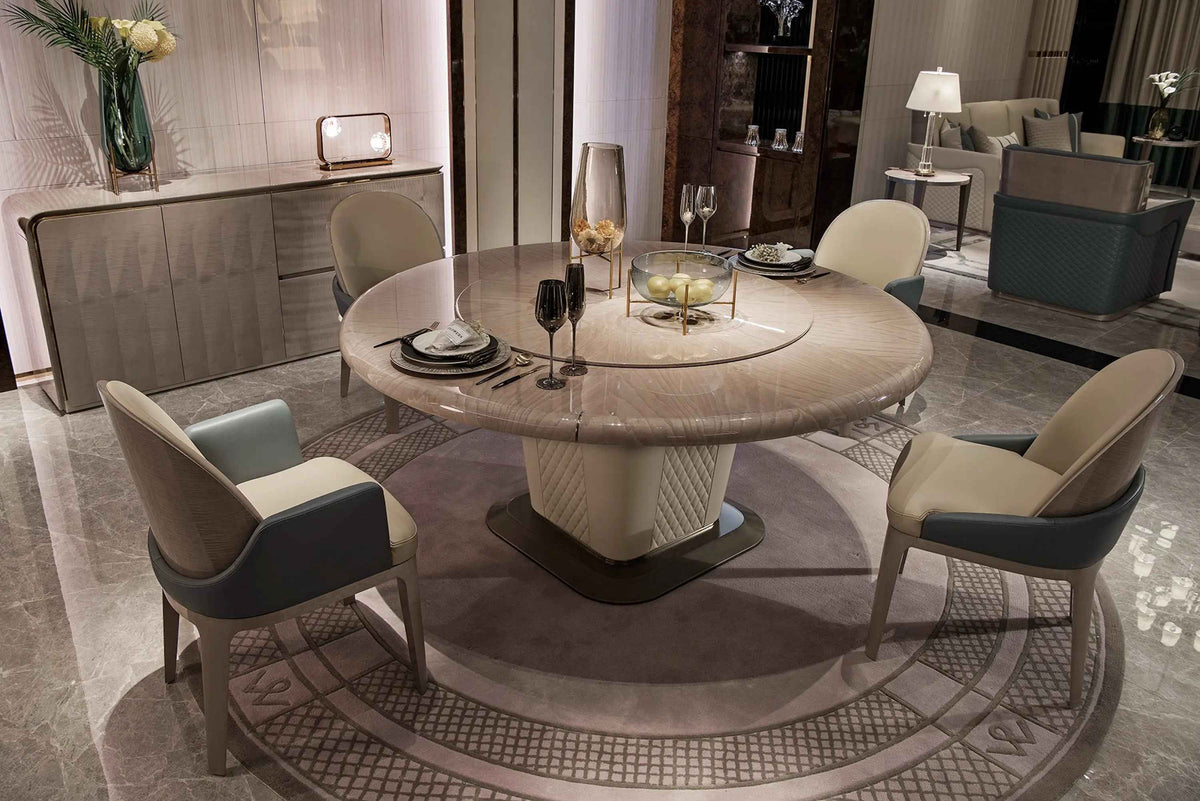 Round wood veneer dining table and upholstered chairs in a coordinated dining room