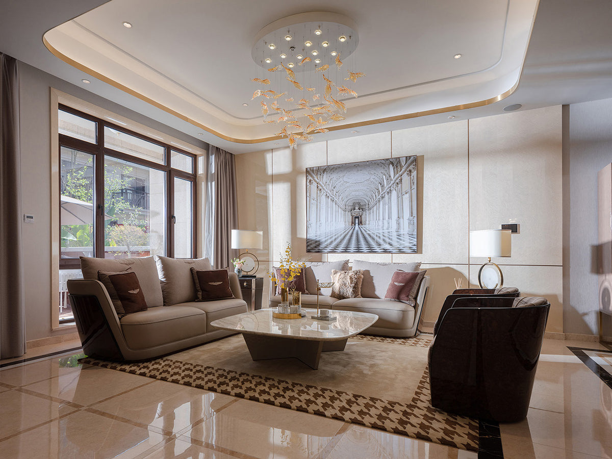 Sofas, a marble coffee table and lounge chairs in a furnished villa living room
